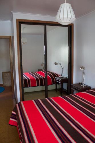 a hotel room with two beds and a mirror at Our sweet flat by the beach in Viana do Castelo