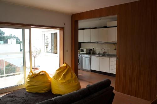 a living room with two yellow bags on a couch at Our sweet flat by the beach in Viana do Castelo