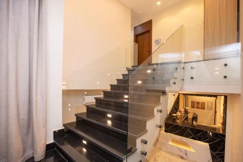 a staircase in a house with a glass railing at New dust pyramids hotel in Cairo
