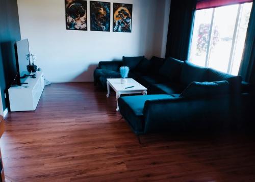 a living room with a couch and a table at Loo puhkemaja Saaremaal in Kudjape
