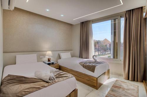 a hotel room with two beds and a window at New dust pyramids hotel in Cairo