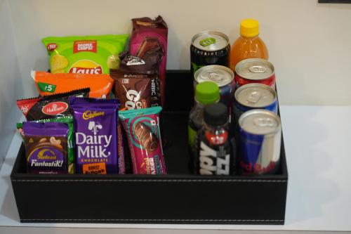 a shelf with a variety of snacks and drinks at VOVO Boutique Hotel in Bengaluru