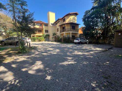 a parking lot in front of a house at Studios Aromas do Campeche - Floripa in Florianópolis