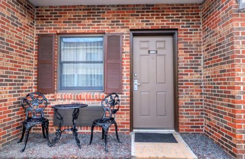 two chairs and a table in front of a brick building at Senator Inn & Spa in Augusta