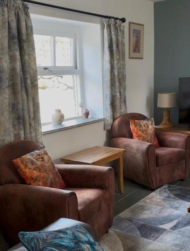 a living room with two chairs and a window at Moorview Retreat, Dartmoor in Widecombe in the Moor