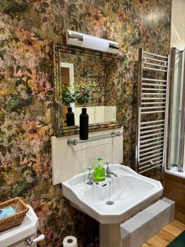 a bathroom with a sink and a mirror at Moorview Retreat, Dartmoor in Widecombe in the Moor