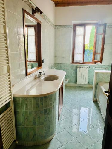 a bathroom with a large sink and a tub at Nibbio III - Entire house in the heart of Chianti in Lucardo