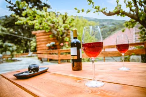 two glasses of wine sitting on a wooden table at Ellafos Traditional Living in Elafonisi