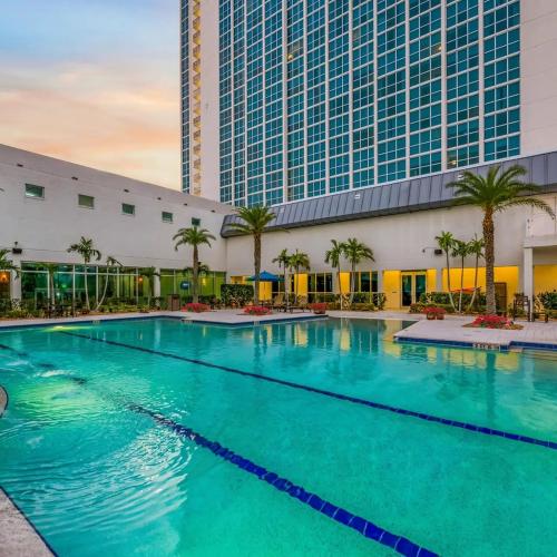 a large swimming pool in front of a building at Luxe Stay Water & City View in Downtown Ft Myers in Fort Myers