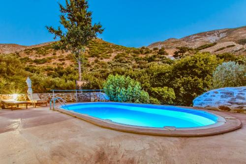an image of a swimming pool with a mountain at Ellafos Traditional Living in Elafonisi