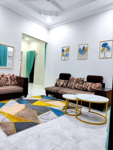a living room with a couch and a coffee table at ZIYA Homestay in Jertih