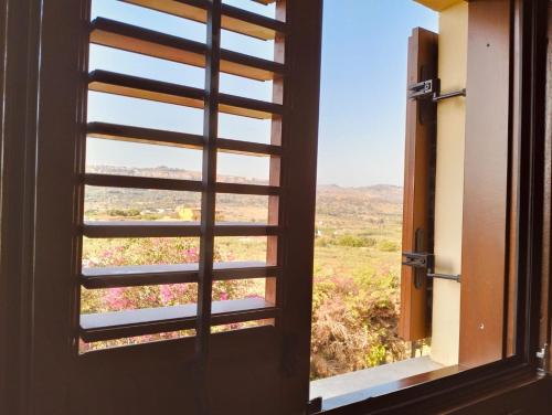 an open window with a view of a field at Hotel Foresteria Baglio Della Luna in San Leone