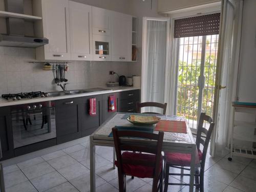 a kitchen with a table and chairs and a table and a table and a kitchen at Casa Nicoletta Apartment in Ravenna