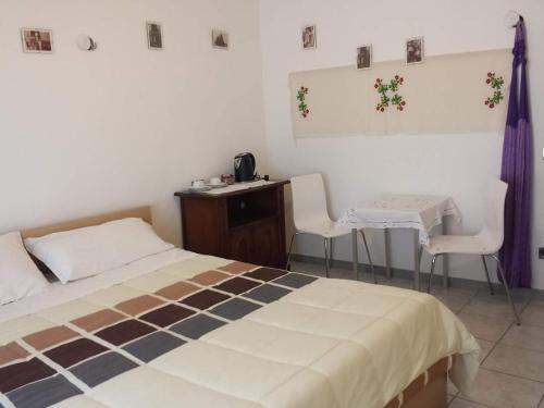 a bedroom with a bed and a table and chairs at Casa Nicoletta Apartment in Ravenna