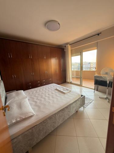 a bedroom with a large bed and a large window at 12valentina in Vlorë