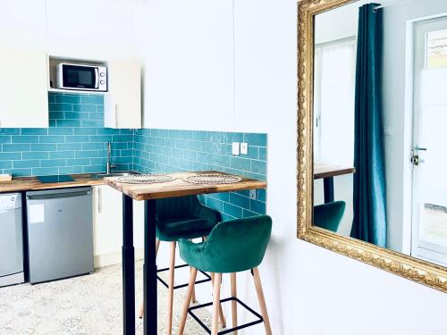 - une cuisine avec un miroir, une table et des chaises dans l'établissement Loft Strasbourg proche Petite France, à Strasbourg