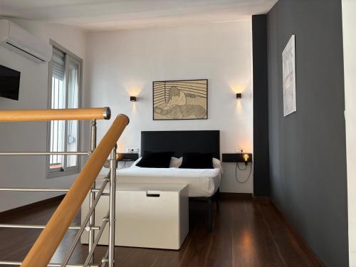a bedroom with a bed and a staircase in it at Loft Almagro in Almagro