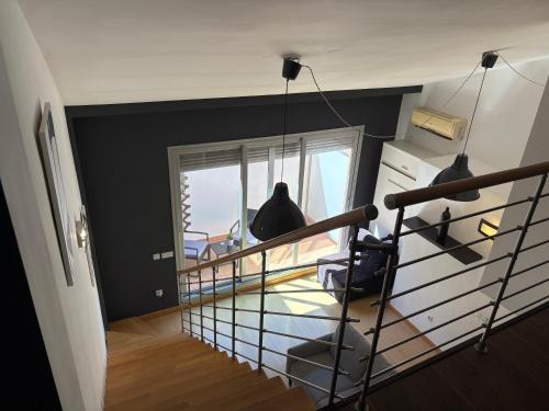 a room with a staircase with black walls and a window at Loft Almagro in Almagro