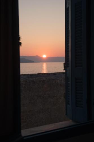 a view of the sunset from the door of a beach at Pension Nora in Chania