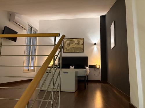 a bedroom with a staircase and a bed in a room at Loft Almagro in Almagro