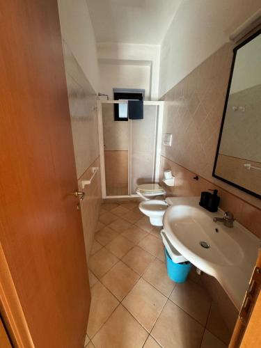 a bathroom with two toilets and a sink at La Piana Di Calena in Peschici