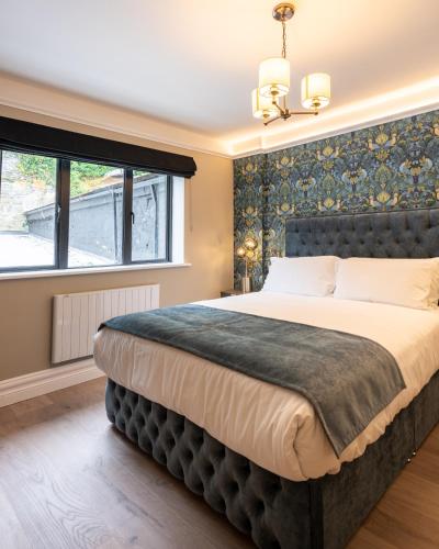 a bedroom with a large bed and a window at No 5 Rose Inn Street - Room 2 in Kilkenny