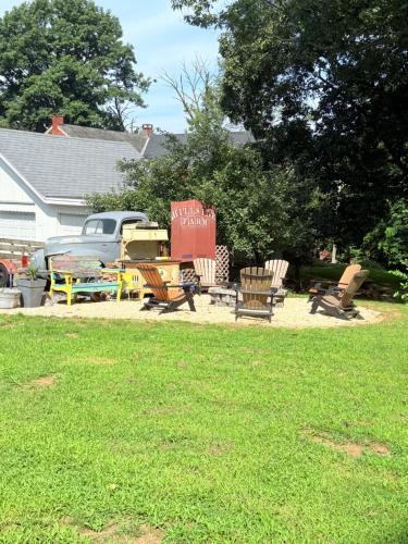 a group of chairs sitting in a yard next to a house at HIllside Farm B & B in Mount Joy