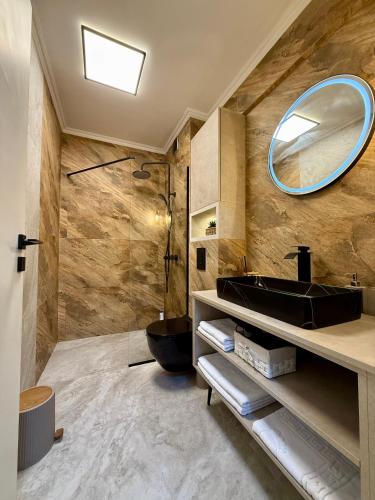 a bathroom with a sink and a mirror at Noble Stay in Saturn