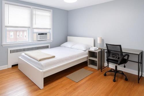 a bedroom with a bed and a desk and a chair at Cozy Drexel Hill Retreat - Perfect for Families in Drexel Hill