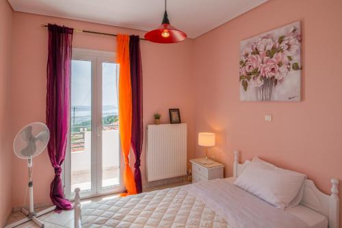 a bedroom with a bed and a window with a view at Aliki's Residence in Kaminaráta