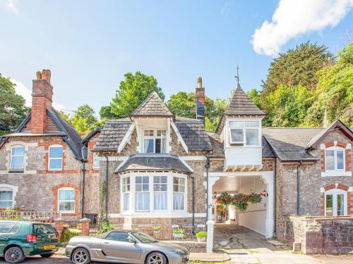 a house with a car parked in front of it at The Coach House At Vane Hill in Torquay