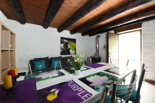 a dining room with a table with flowers on it at Rustic on the Verzasca River in Corippo