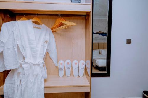 a white robe and shoes in a closet at 凯丽酒店Kiri Hotel at Kigali Rwanda in Kigali