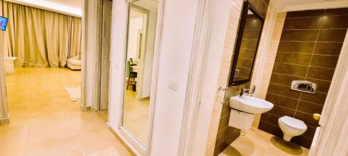 a bathroom with a toilet and a sink at Sentido Marillia Resort & Spa in Hammamet