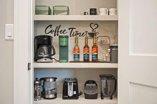 a cupboard with a coffee time sign on it at Onyxthelark Designer Edmond Oasis in Edmond