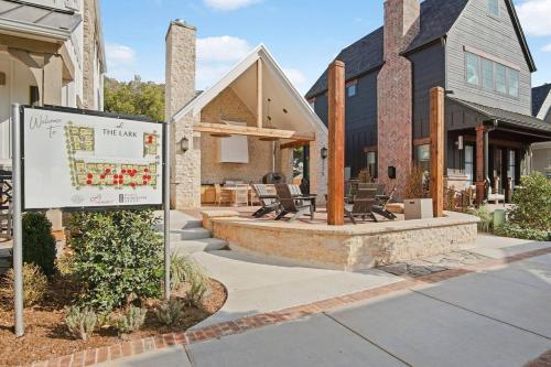 a sign in front of a house with a building at Onyxthelark Designer Edmond Oasis in Edmond