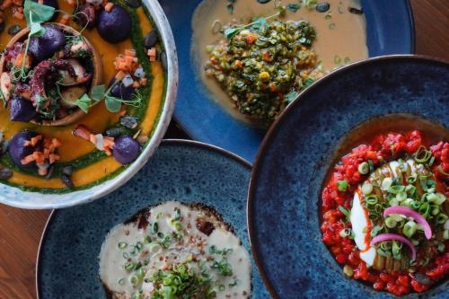 a table with three bowls of food on plates at Le Homard Bleu in Saint-Trojan-les-Bains