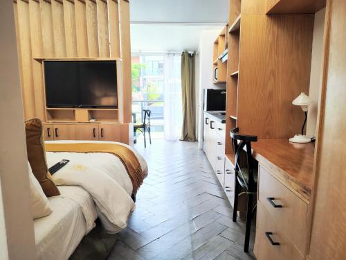 a hotel room with a bed and a television at CASA NIAGARA in Mexico City