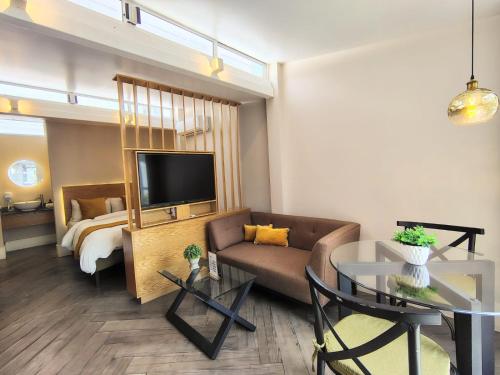 a living room with a couch and a bed at CASA NIAGARA in Mexico City