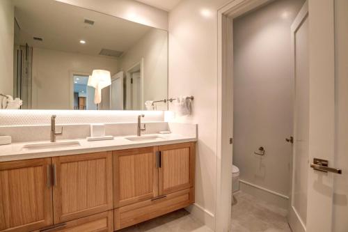 a bathroom with two sinks and a mirror at Honua Kai Luana Condos by KBM Resorts in Kaanapali