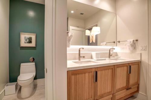 a bathroom with two sinks and a toilet at Honua Kai Luana Condos by KBM Resorts in Kaanapali