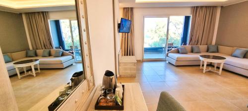 a living room with a couch and a mirror at Sentido Marillia Resort & Spa in Hammamet
