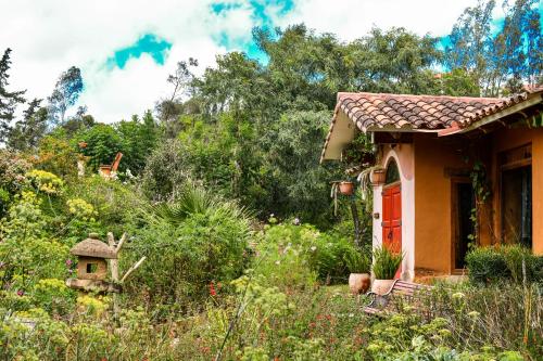a small house in the middle of a garden at Casa Samai Boutique in Samaipata