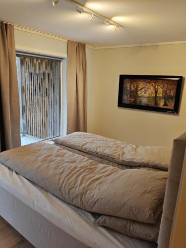 a bed in a bedroom with a window at Hagekjeråsen 18 B in Lyngdal