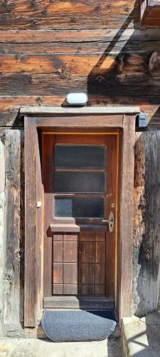 a door in the side of a wooden building at Chalet Bernadette in Mörel