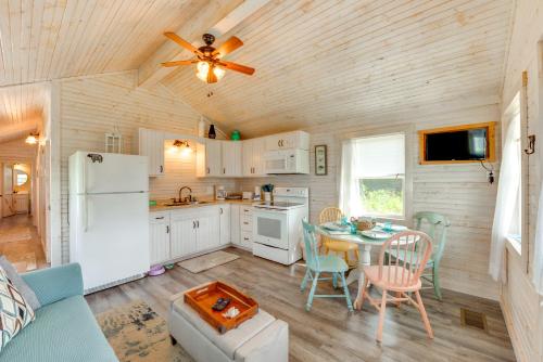 a kitchen with a table and a white refrigerator at 2 Mi to Carrabelle Beach Home with Yard and Porch in Carrabelle