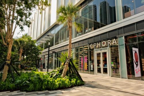 a palm tree in front of a shopping mall at Miami Luxe Escape Best High Waterfront Views, City Lights, Pool, Spa Amazing location in Miami