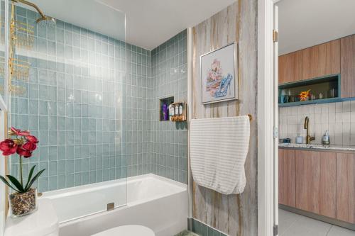 a bathroom with a tub and a toilet and a sink at Miami Luxe Escape Best High Waterfront Views, City Lights, Pool, Spa Amazing location in Miami