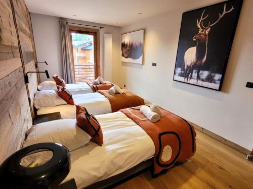 a room with four beds with animals on them at Appartement de Luxe Neuf avec Terrasse au Cœur des Gets, Proche des Pistes et Commerces - FR-1-598-153 in Les Gets