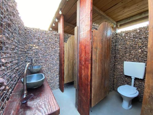 a bathroom with a sink and a toilet at Sea Side Camping in Vama Veche